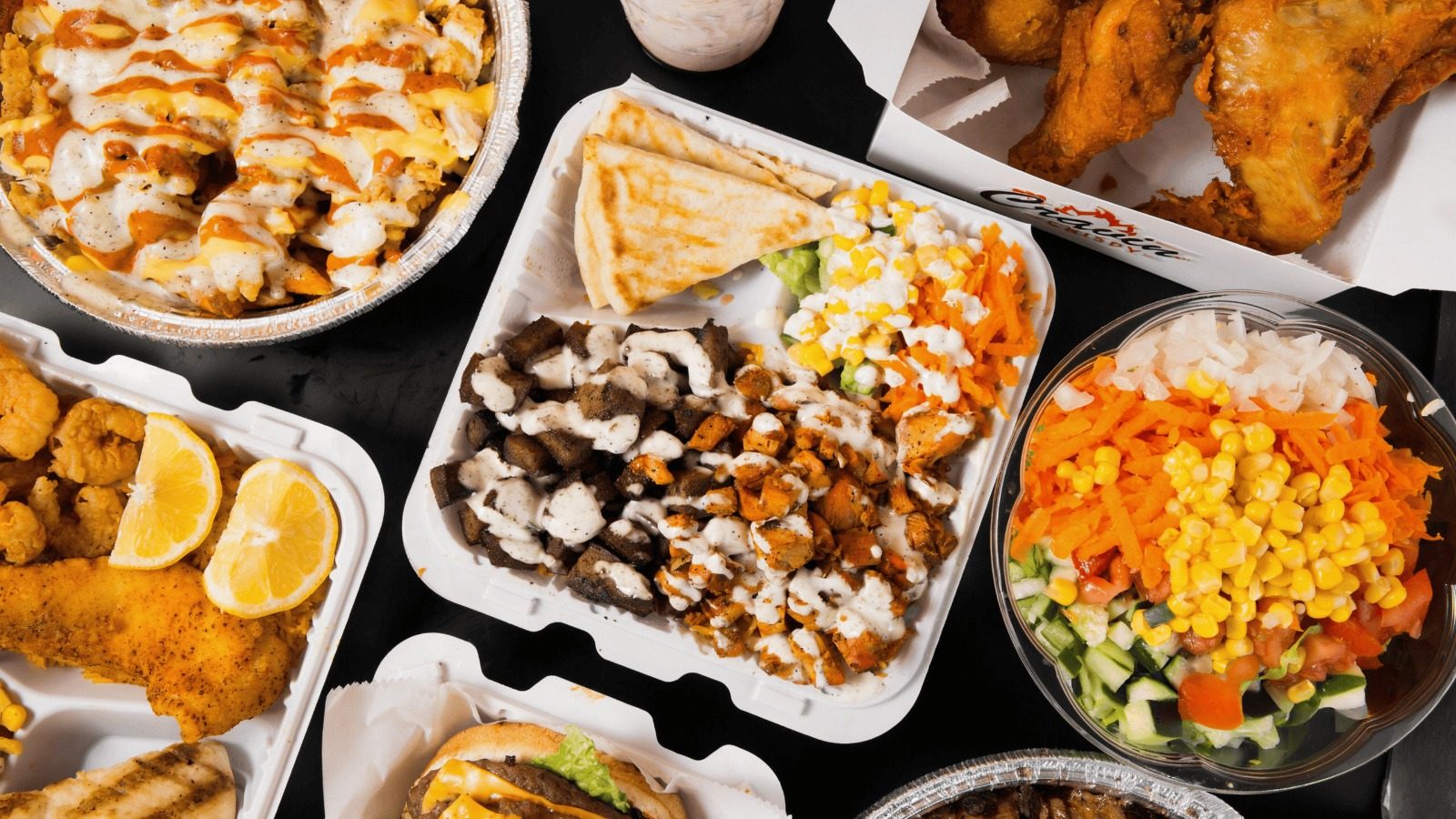 A spread of Cravin Crispy platters, fried chicken, fish and salad